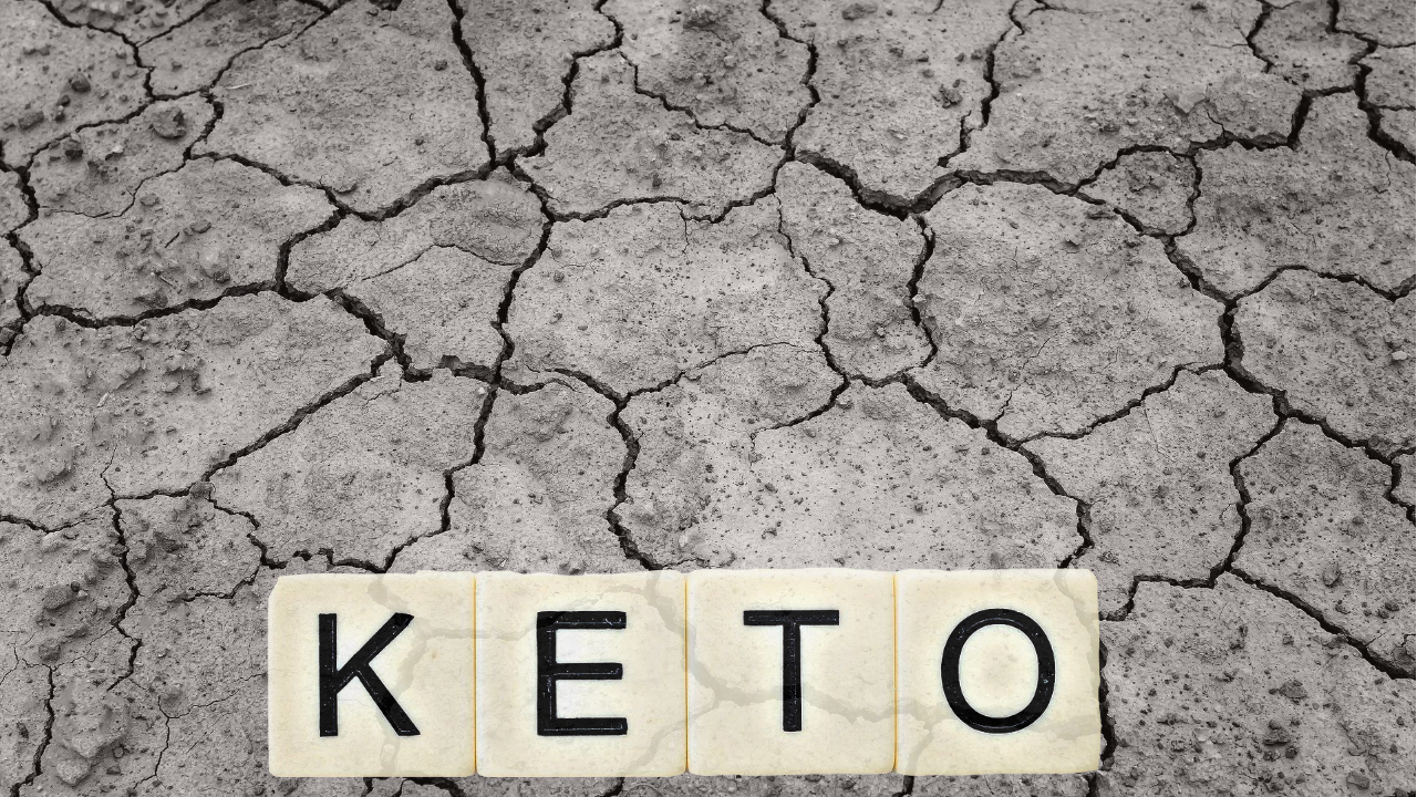 Keto scrabble tiles on dry desert ground 